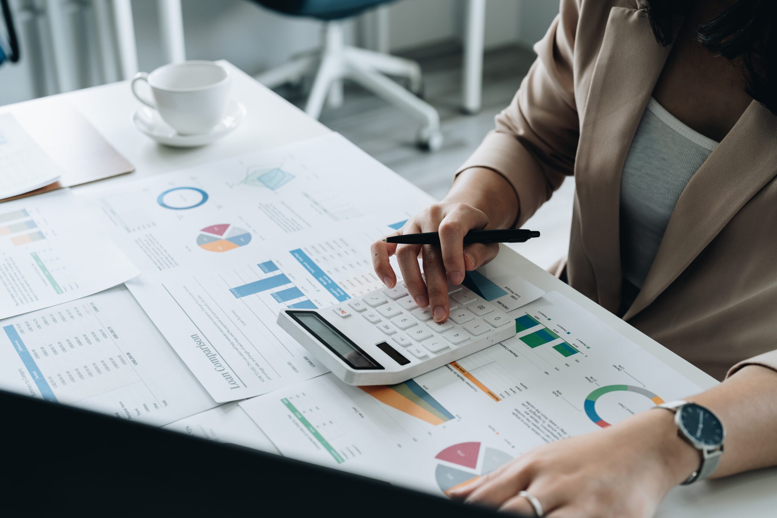Businesswoman Works On Analyzing Financial Data Using A Calculator With Calculations